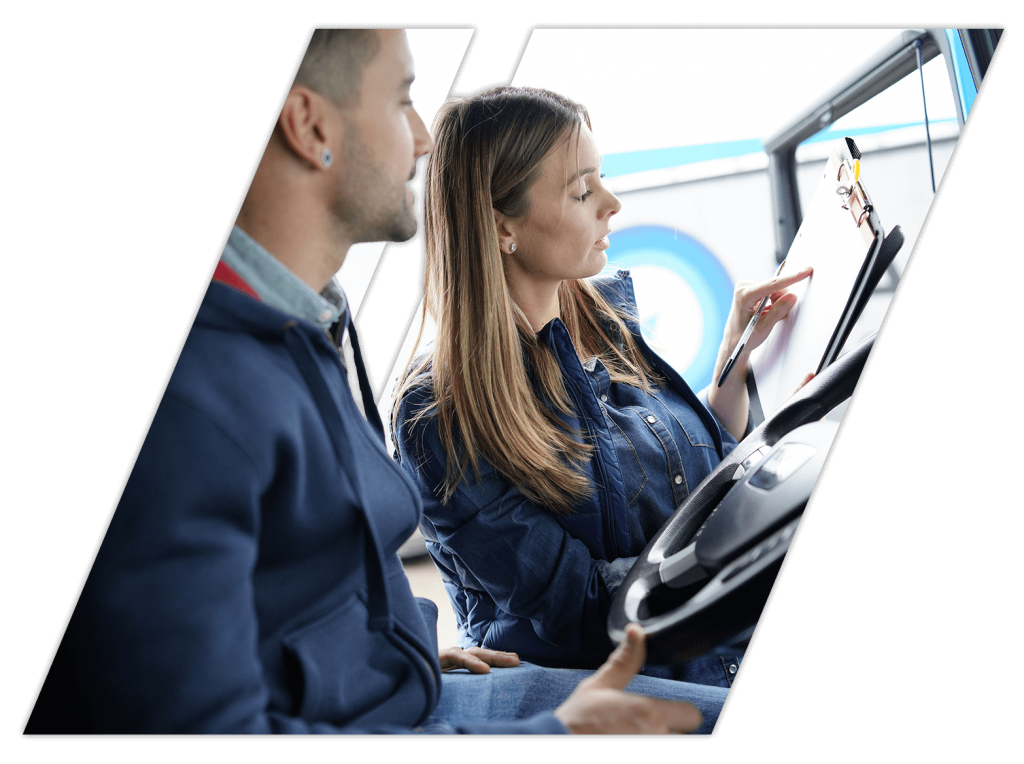 Female instructor giving CDL training to man renewing license