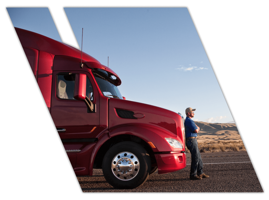 Coastal Truck Driving student leaning on 18 wheeler