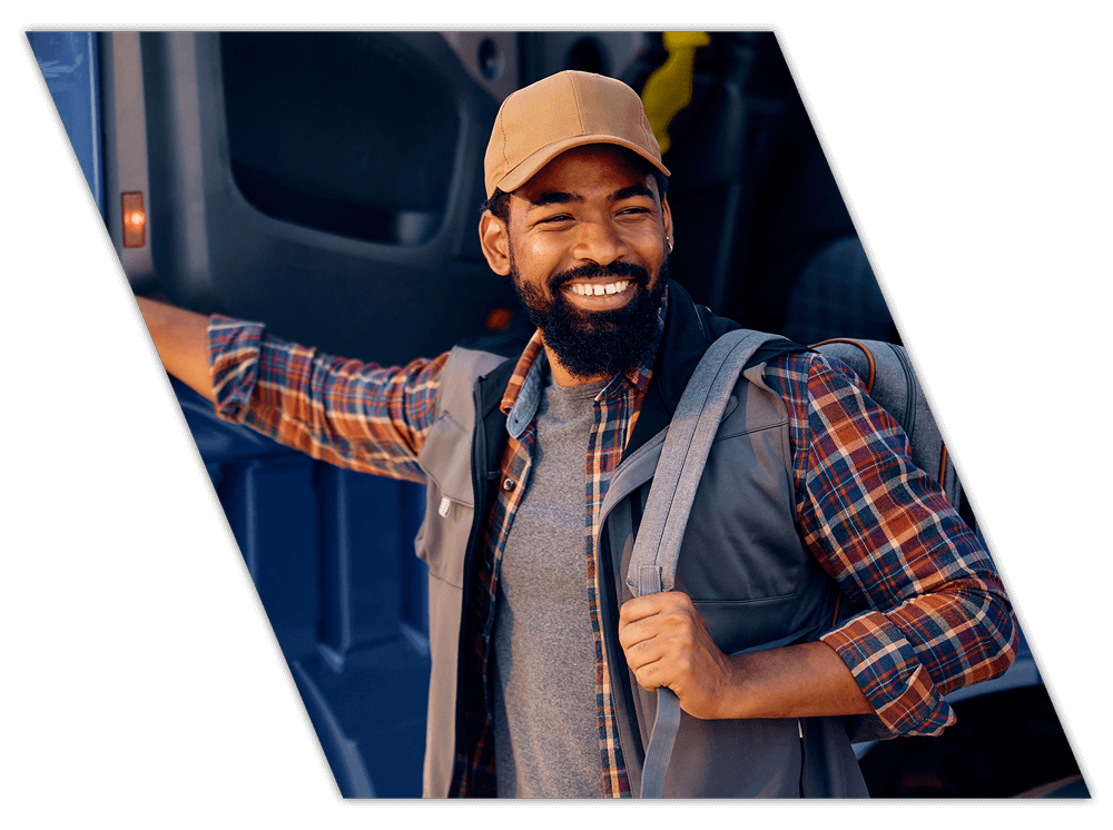Happy truck driver student exiting vehicle for training for company drivers in Alabama
